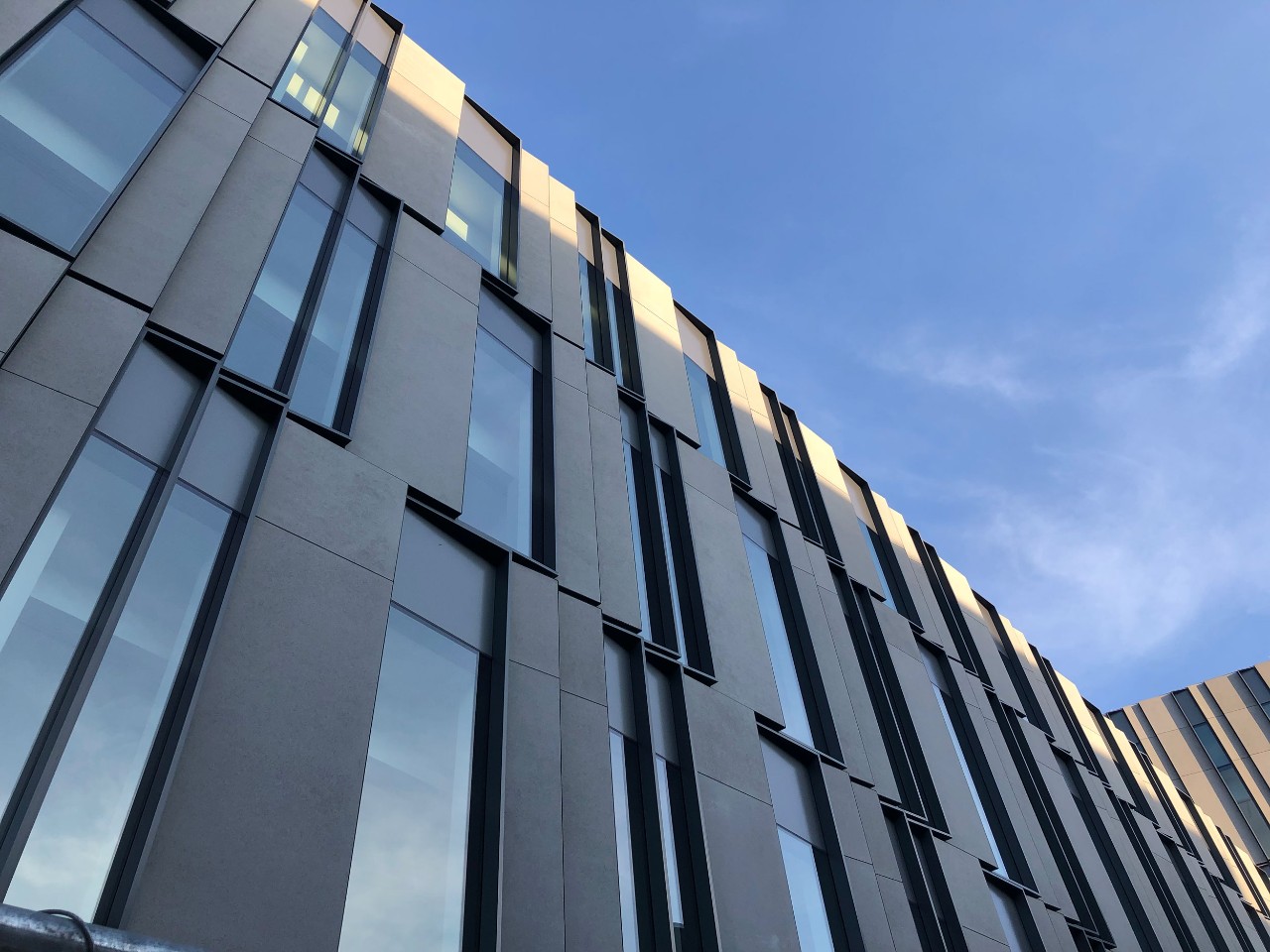 View of Lindner Hall against blue sky on sunny day