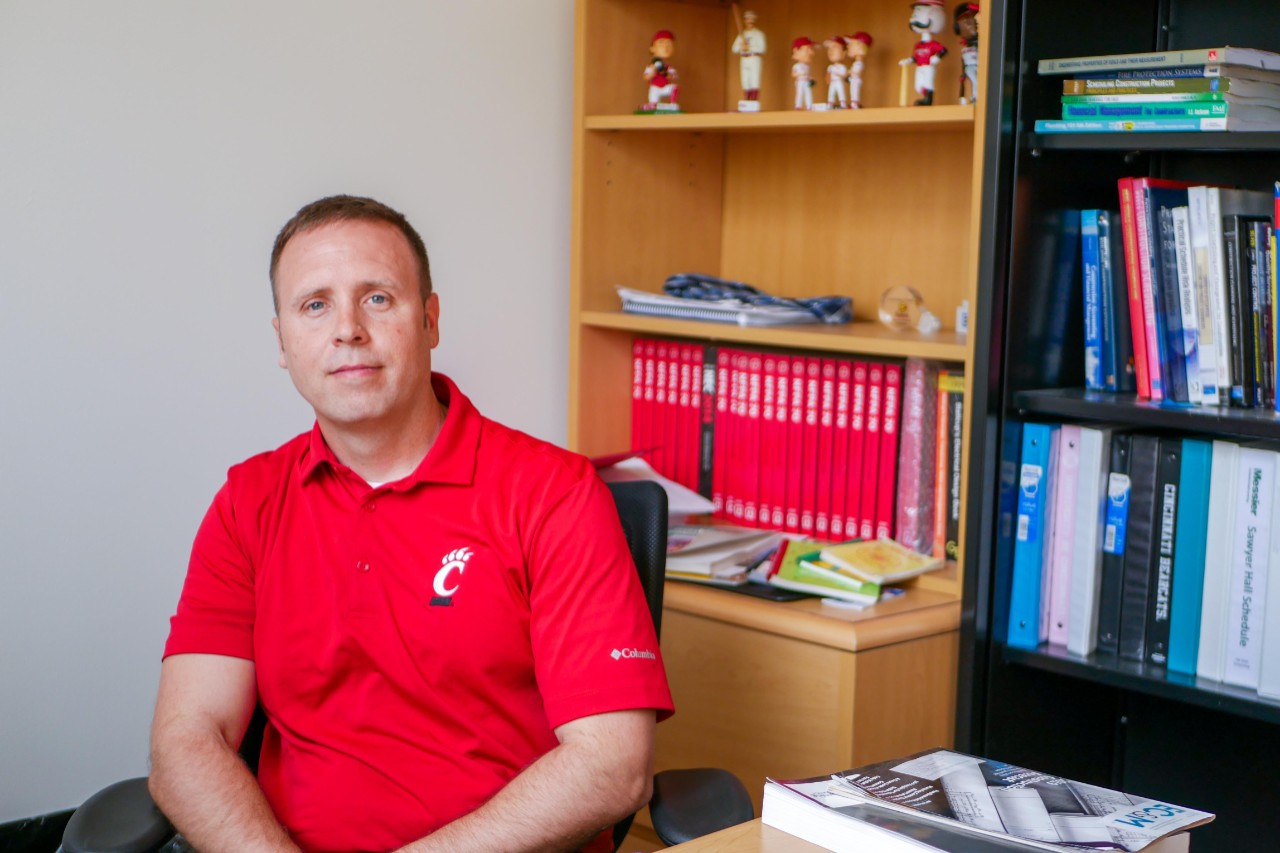 Jason Mack sits in office