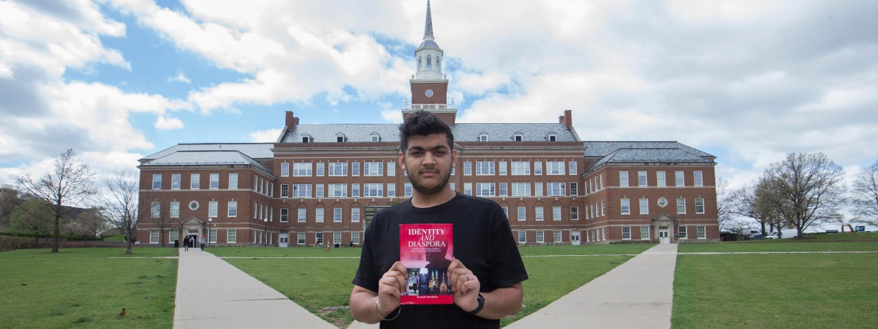 Prateek Srivastava stands in front of McMicken Hall 