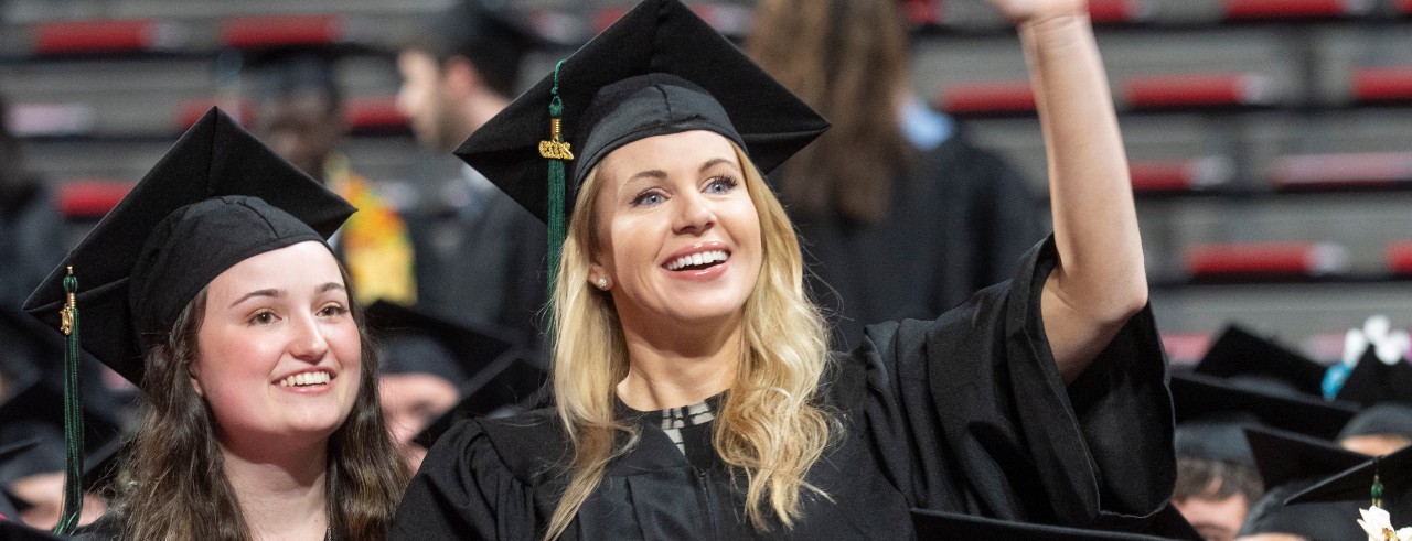 Students smile at Fifth Third Arena during commencement.