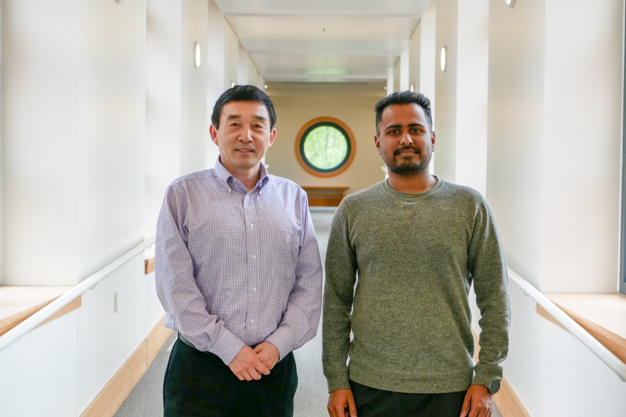 Wei and Kashyap pose in hallway