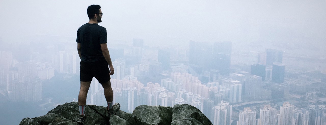 Rash Abdelwahed stand on a mountain overlooking the city of Hong Kong.