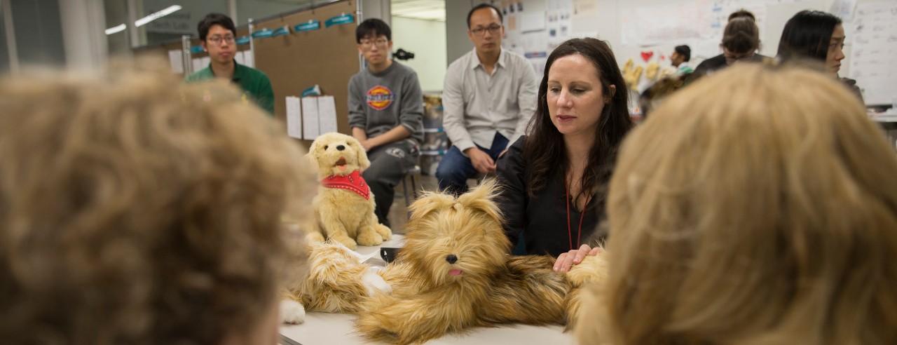 A class and professor showcase robotic dogs