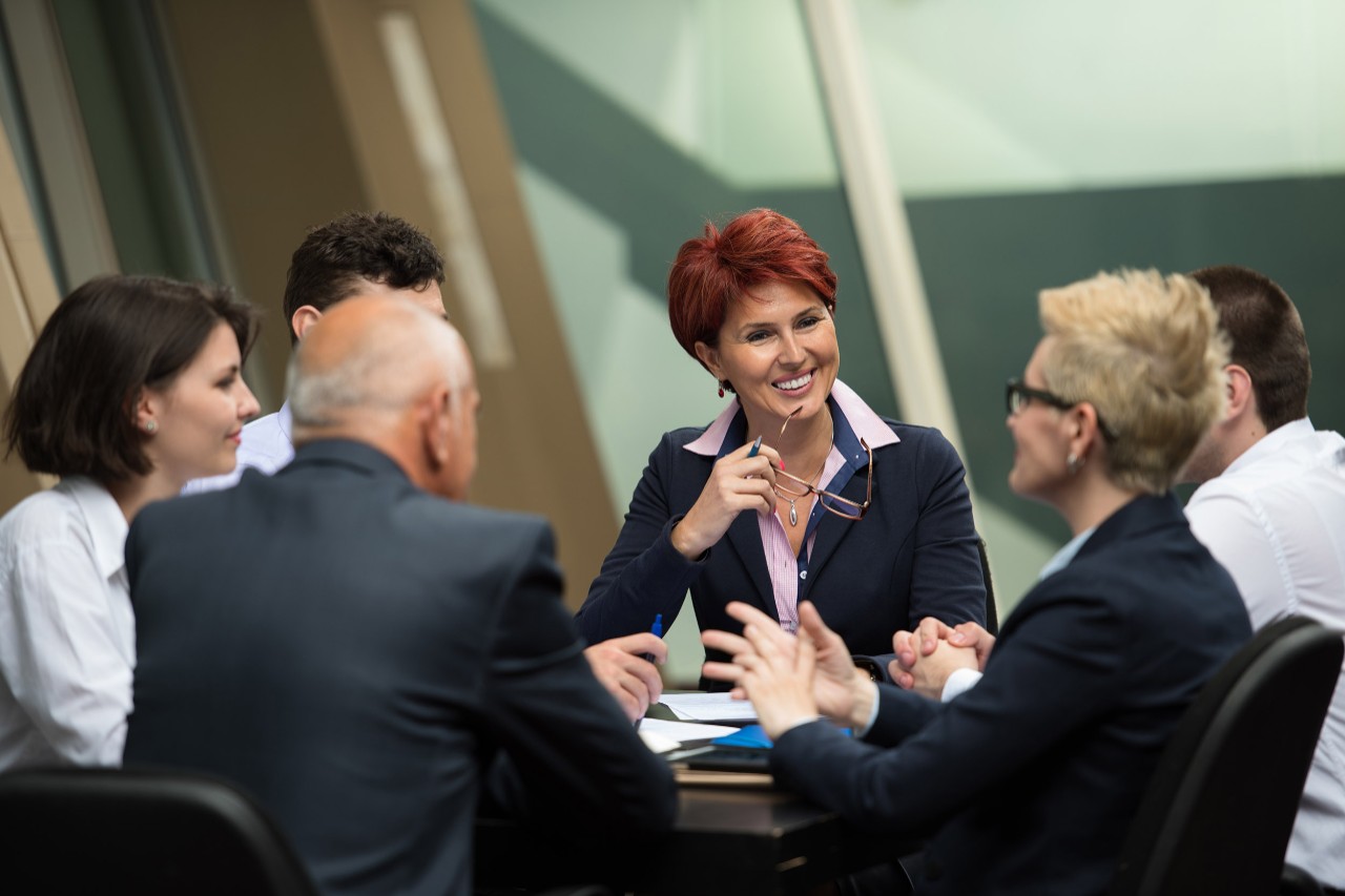 Business people group meeting at modern, bright office.