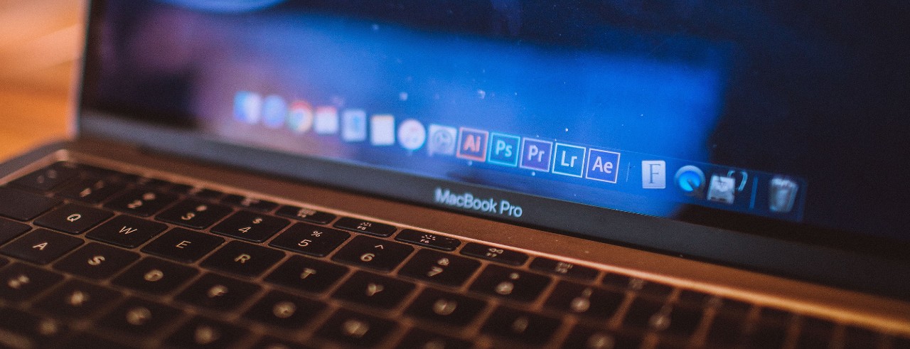 MacBook Pro dock showing Adobe icons
