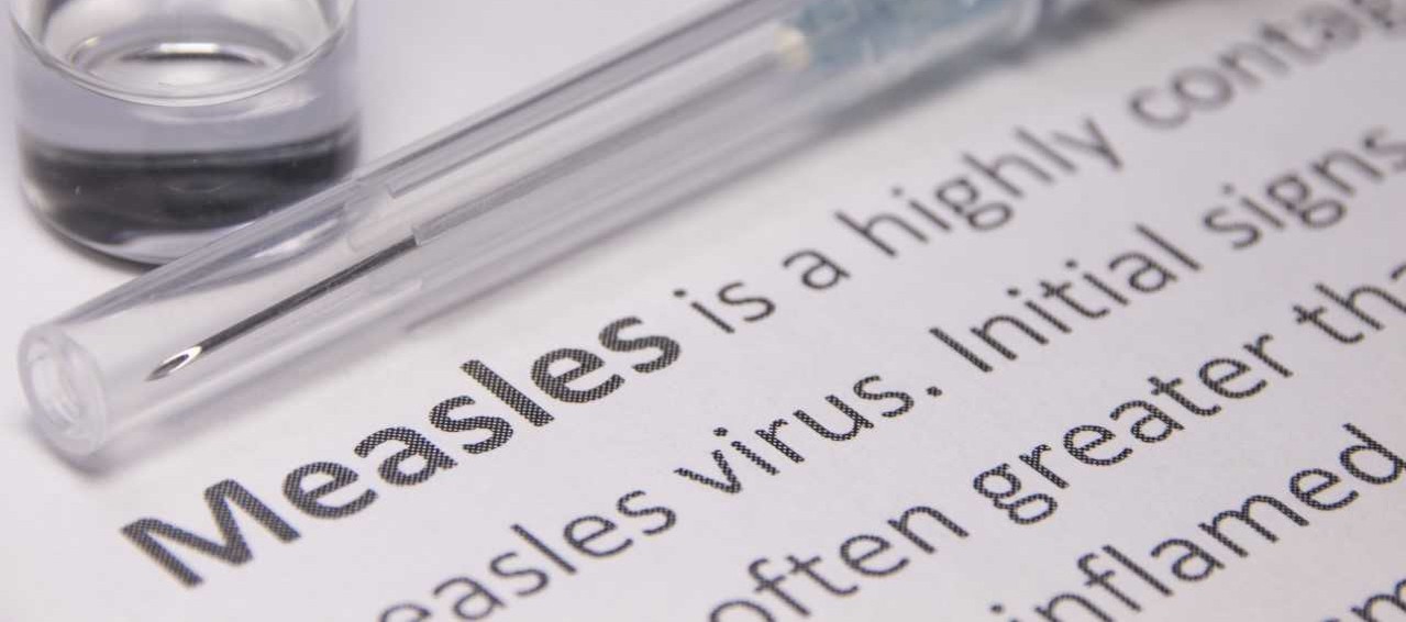 A vial above a description of measles.