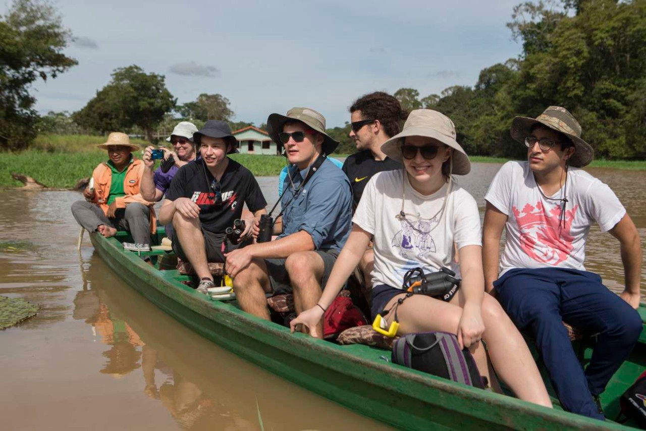 UC students canoe down a river in the Amazon.