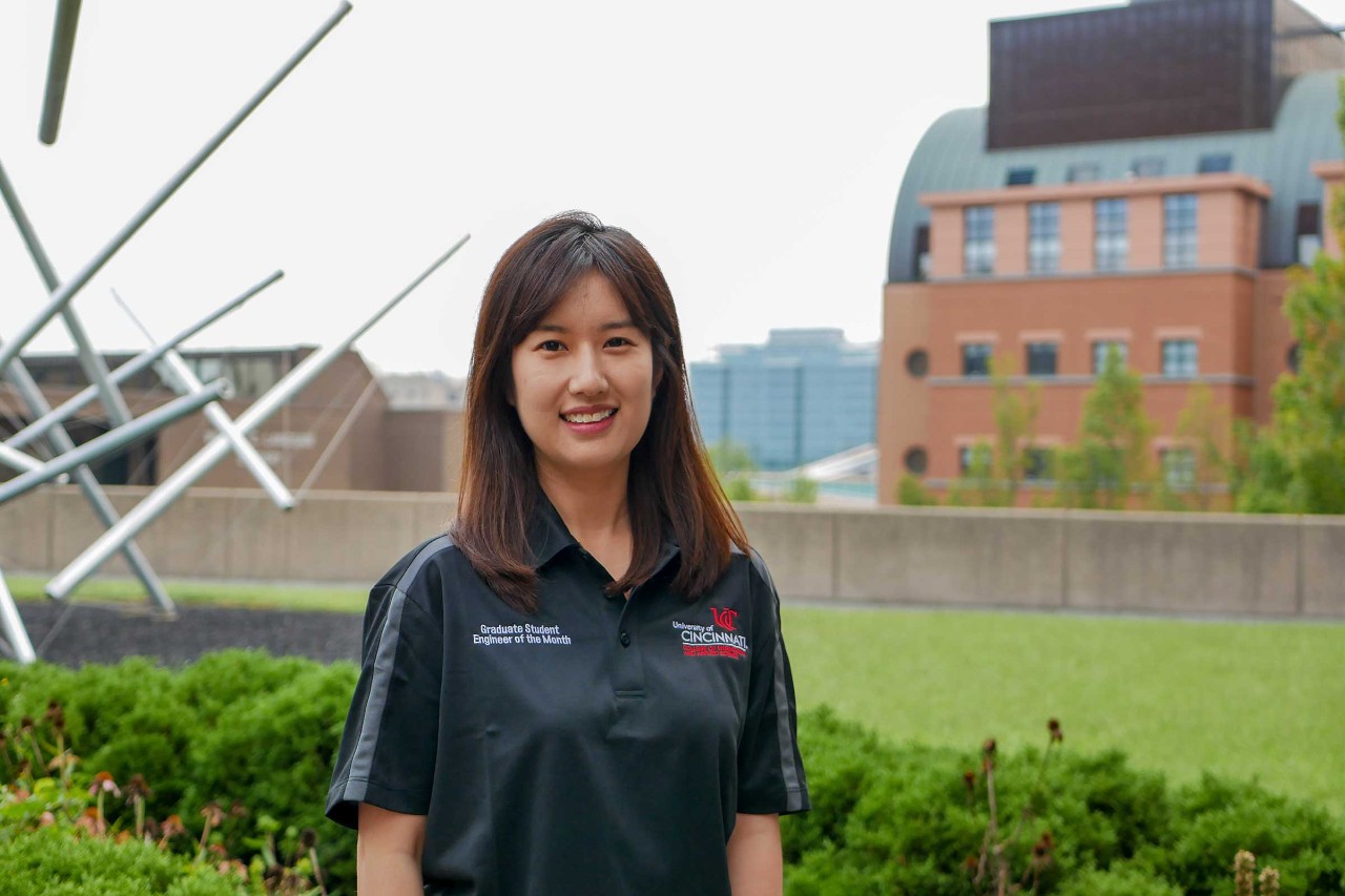 Zishu Cao stands outside of the Engineering Research Center. A sculpture is visible behind Cao on her right.