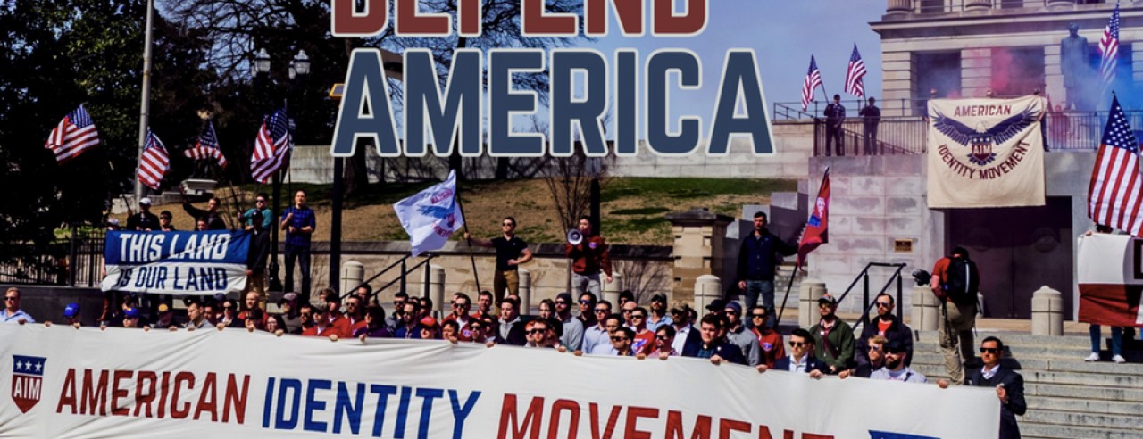 a large group of people hold signs that read "defend america"