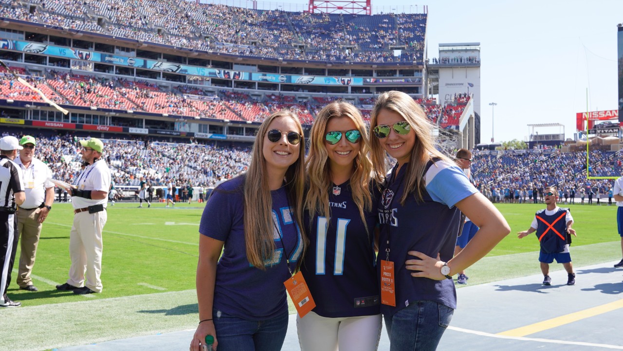 Kassie and friends on the sidelines at a football game in Nashville