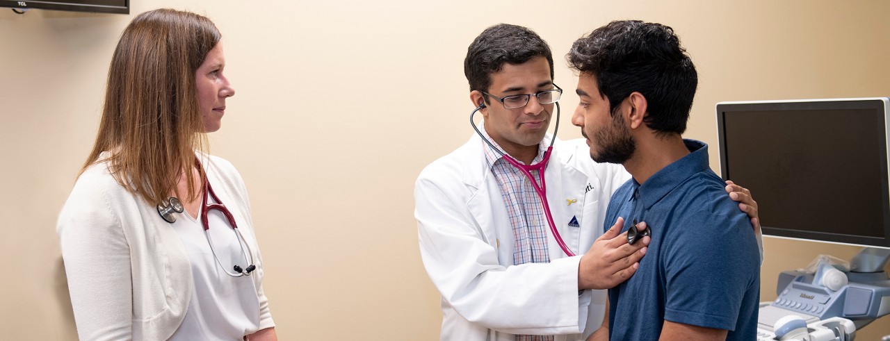 Megan Rich, MD, shown with students Dhruv Kohli and Hem Patel during a simulated doctor-patient encounter