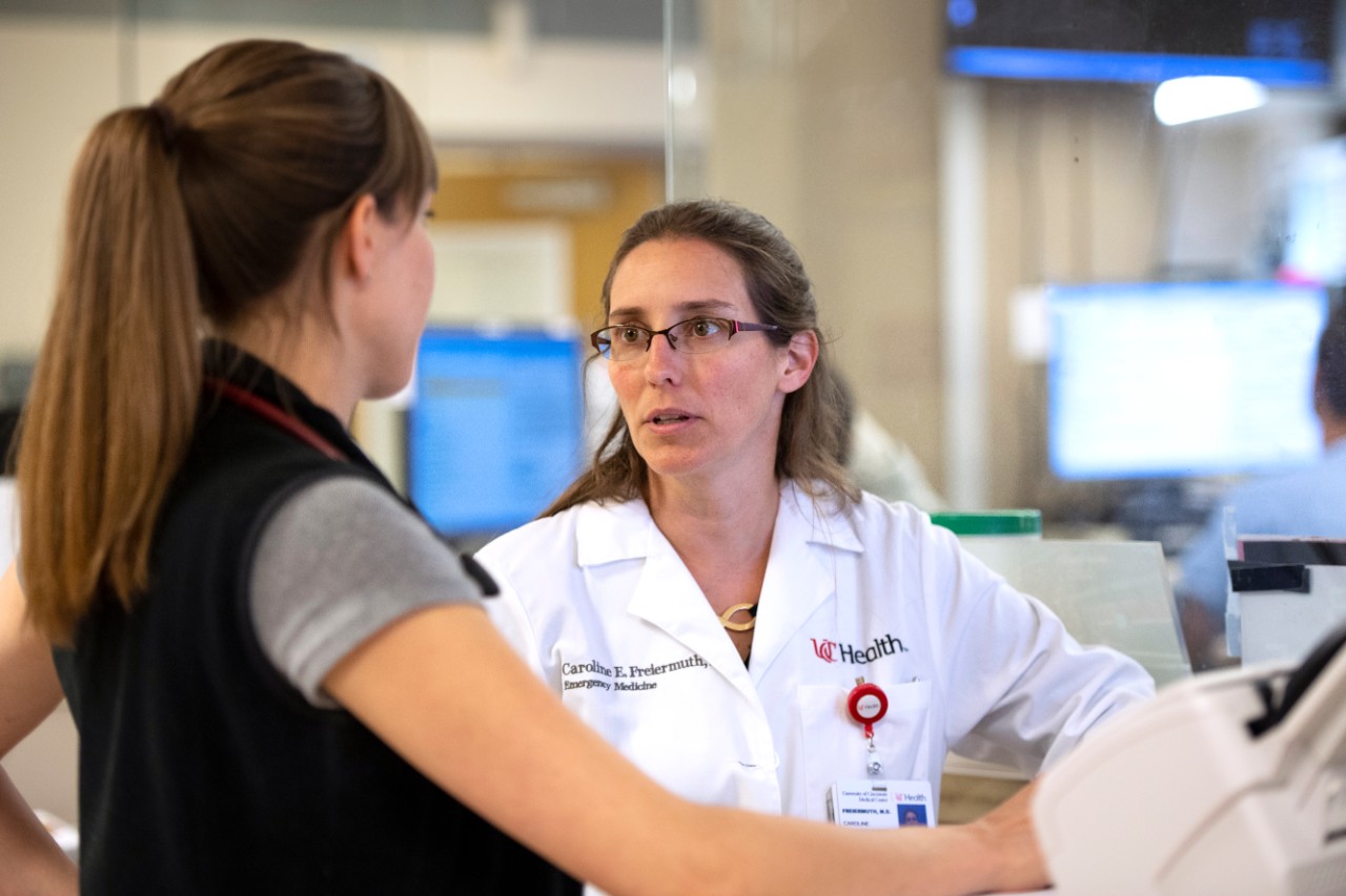 Dr. Caroline Freiermuth consults with a colleague in the Department of Emergency Medicine