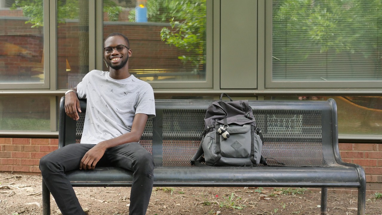 Leo Thiam sitting on bench 