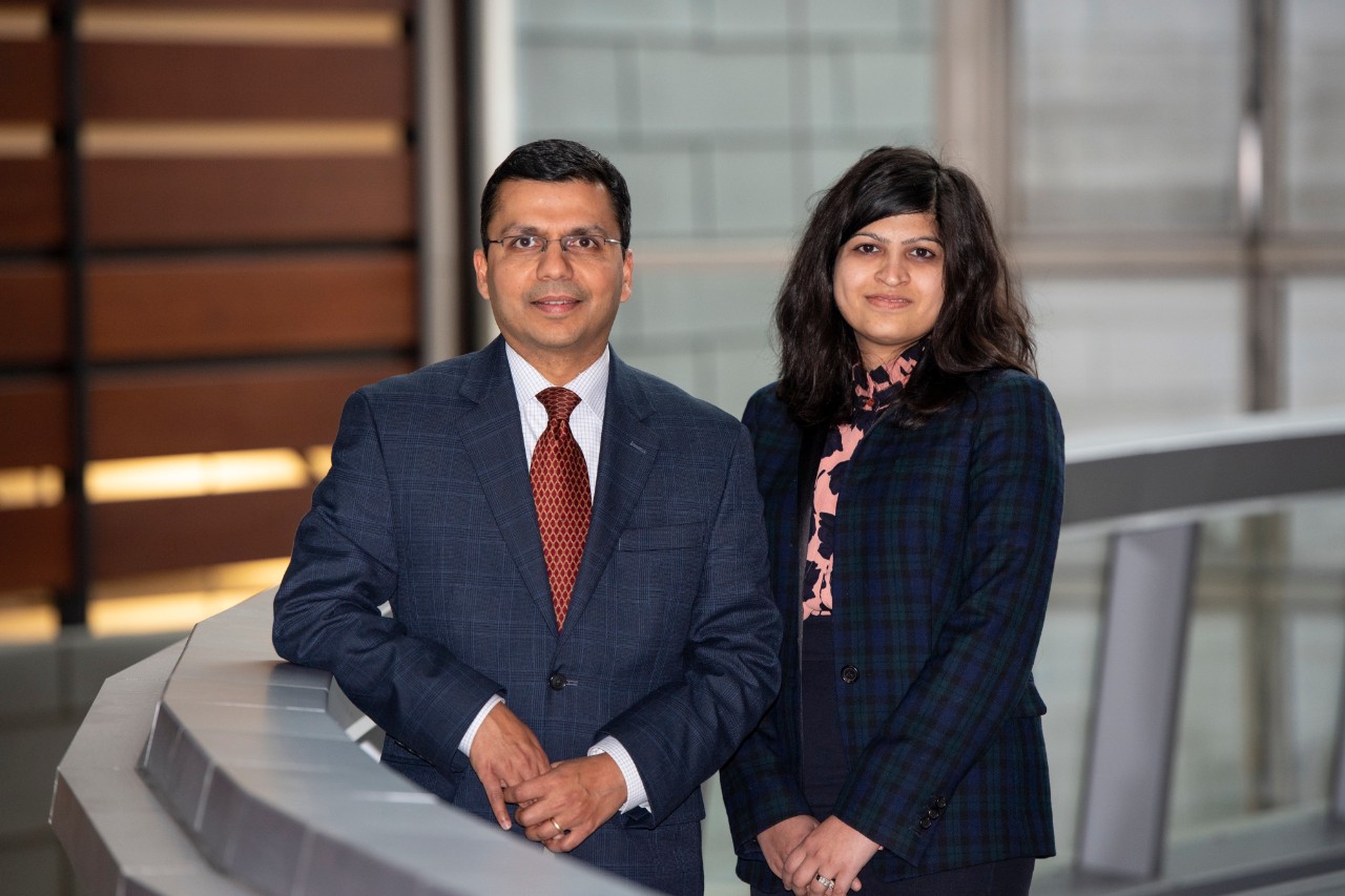 Dr. Charuhas Thakar and Dr. Silvi Shah on a bridge in the CARE/Crawley Building.