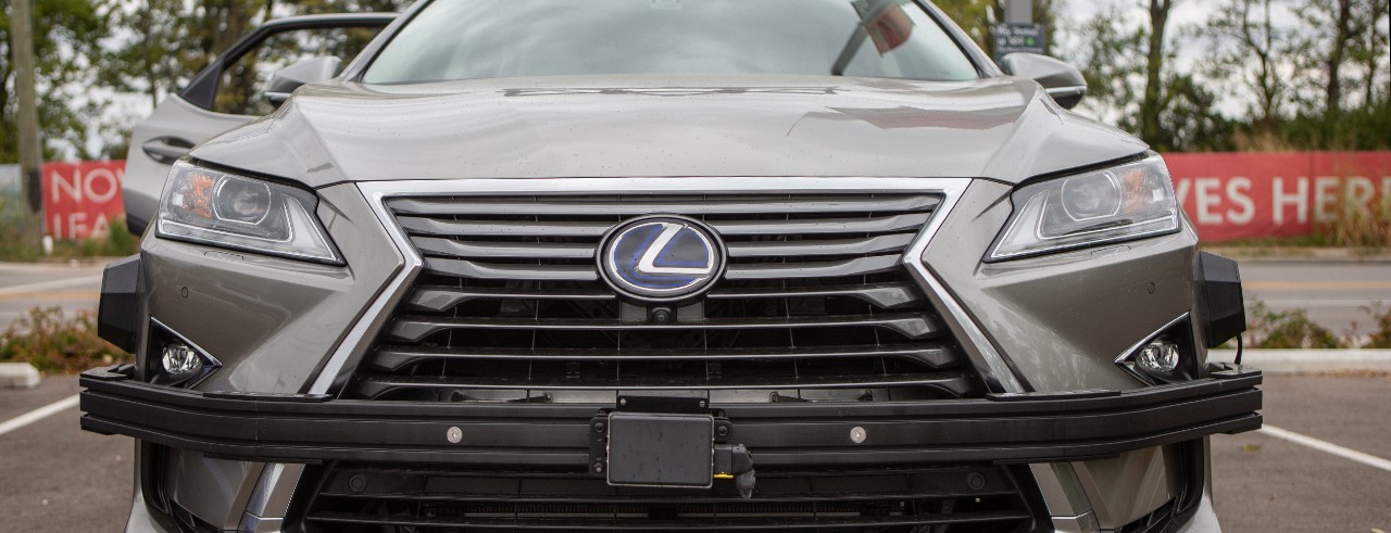 A closeup of the sensors on the bumper of a Lexus hybrid SUV that UC is using for its driverless car research.