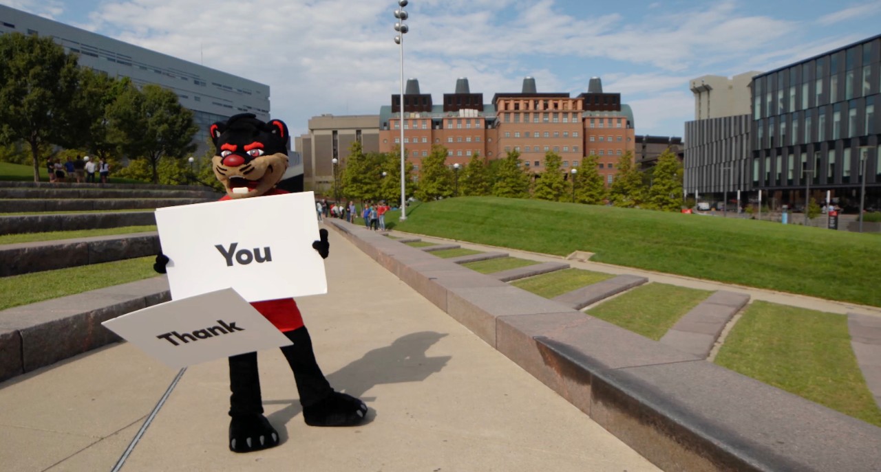 UC Bearcat holds Thank You signs
