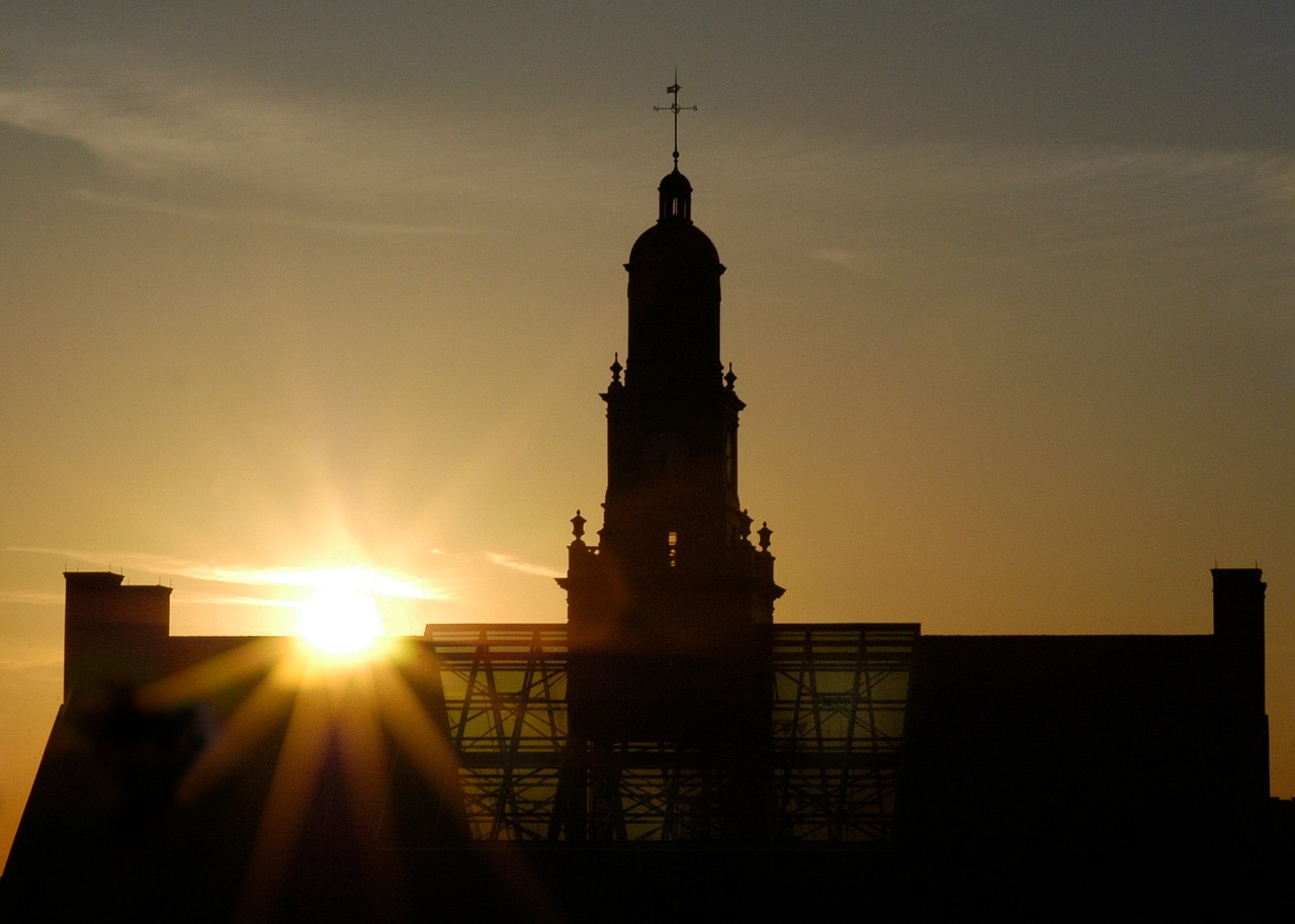 The sun rises over McMicken Hall