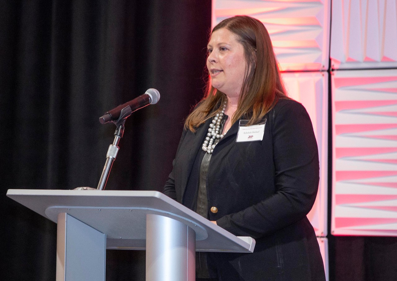 A woman speaking at a podium