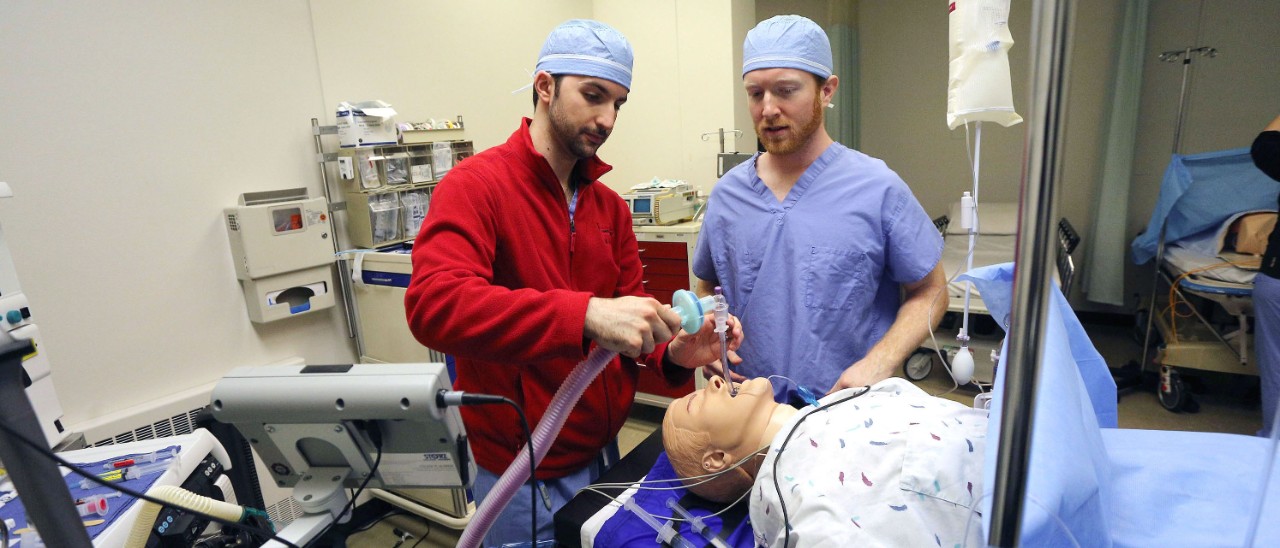 Two nursing students practice skills in the simulation laboratory.