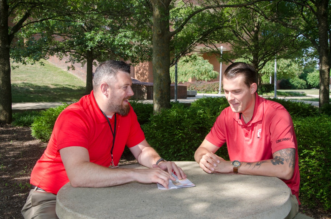 Josh Monson speaks with a student veteran on the UC Blue Ash campus. 