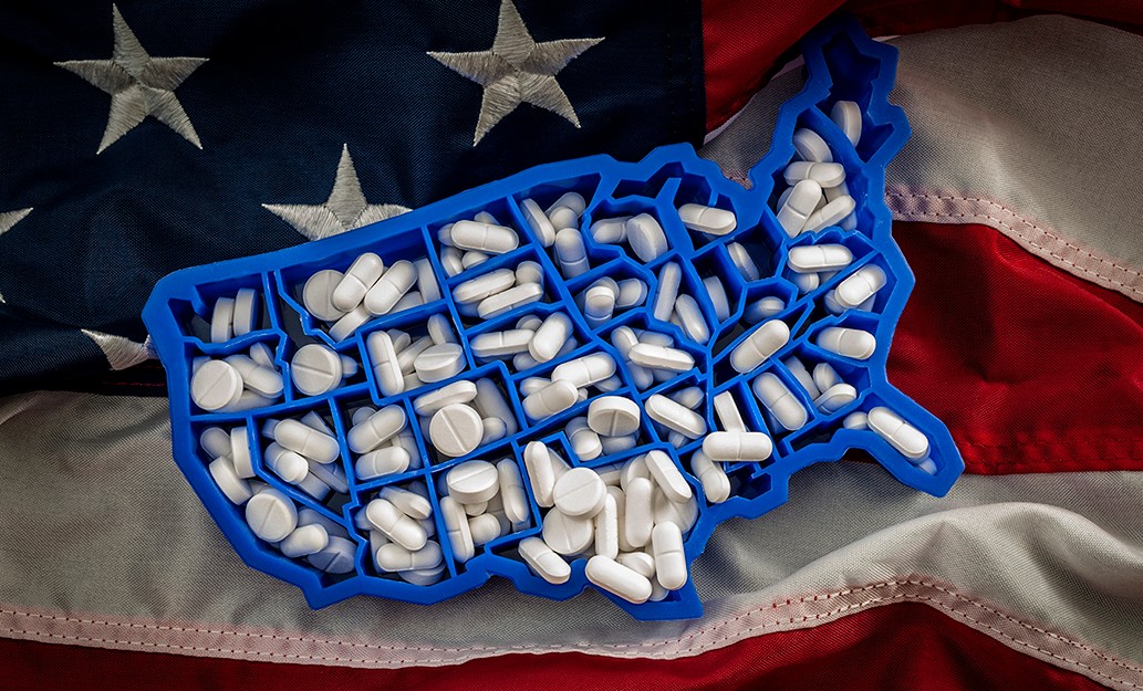 pills in a container shaped like the United States