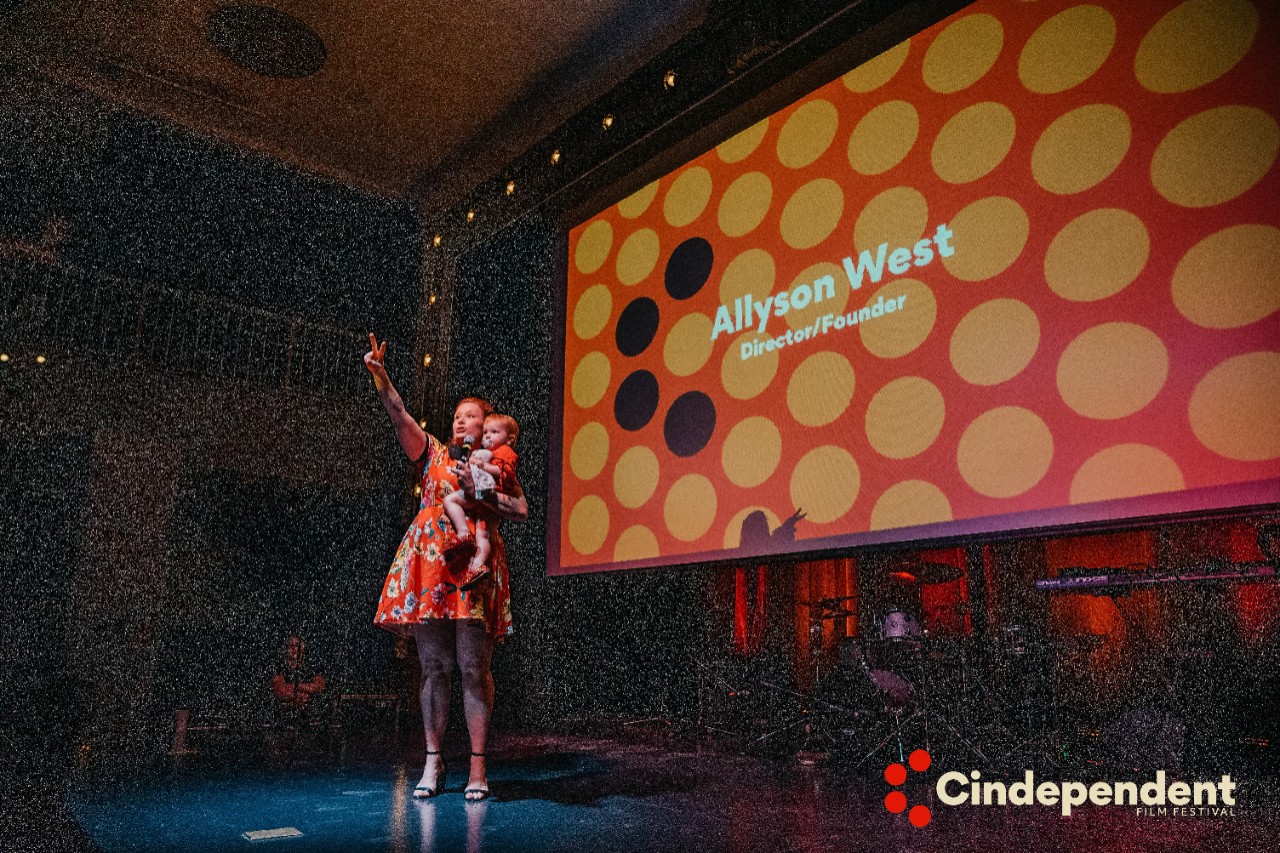 Allyson on stage with daughter, Olive, at opening night of the CINdependent Film Festival.