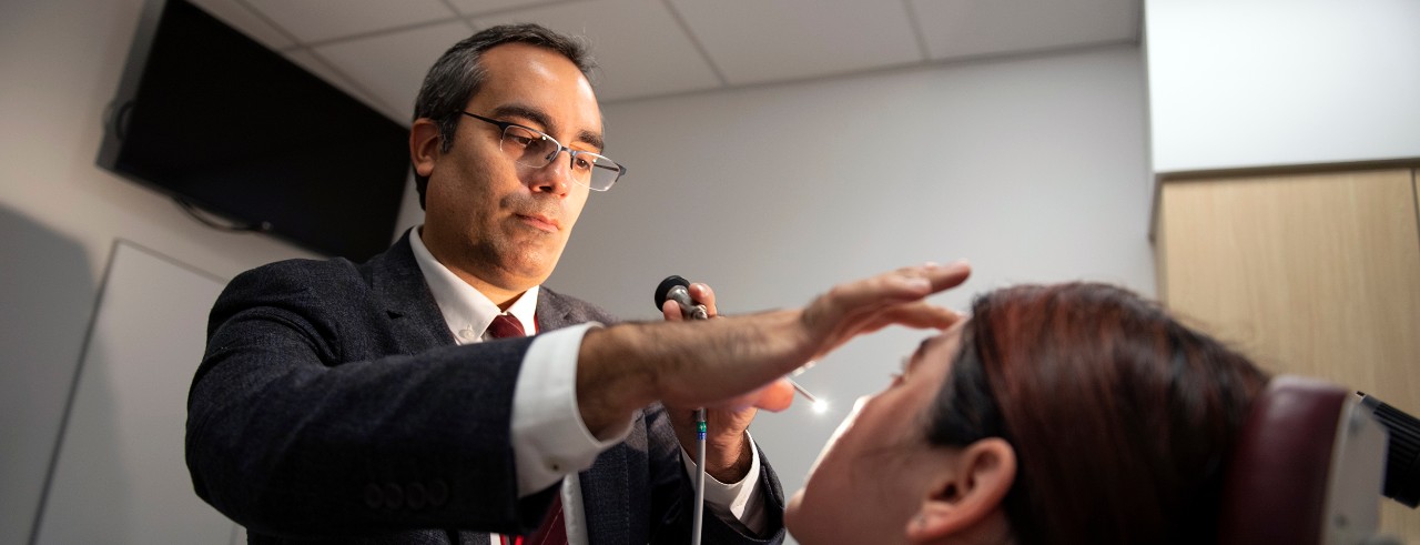 Ahmad Sedaghat, MD, PhD, shown examining a patient.