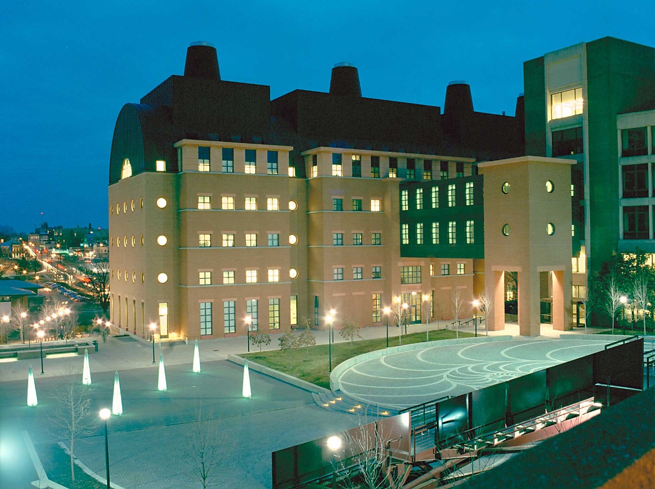 photo of engineering research center and plaza behind it at dusk