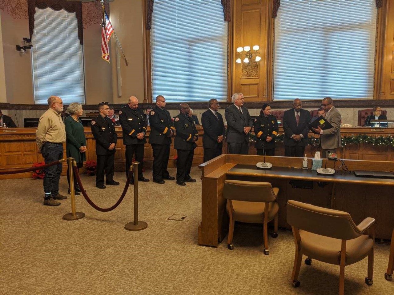 Members of UC Public Safety and the Community Compliance Council stand with Cincinnati Vice Mayor Christopher Smitherman as he reads a resolution commending Public Safety for its accomplishments.