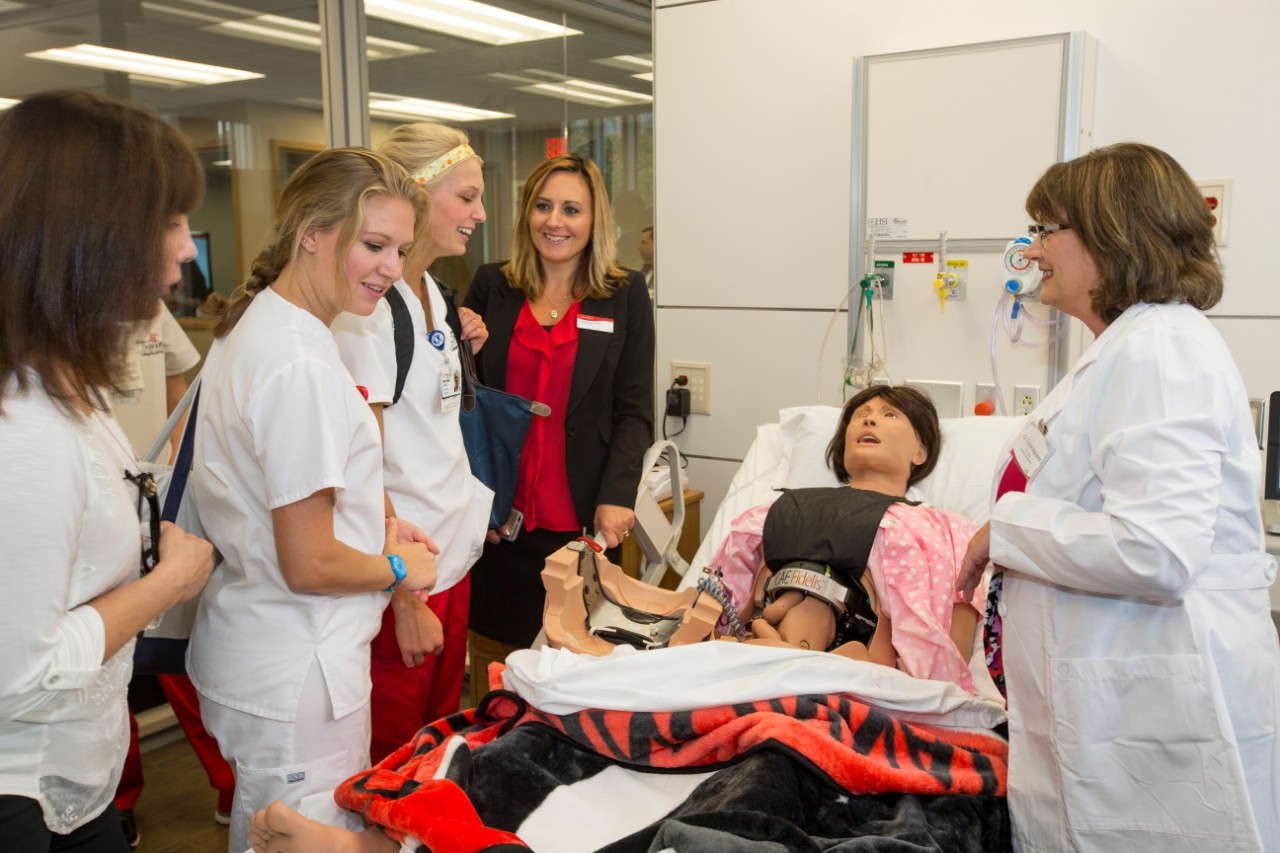 Nursing students with an instructor in a simulation lab