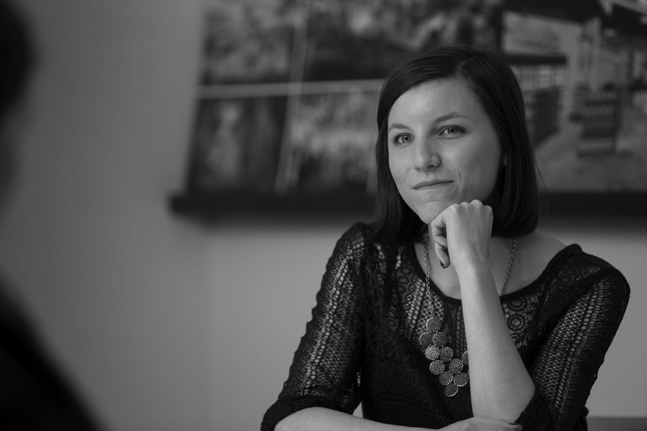 Portrait of student sitting at a table with her chin resting on her hand