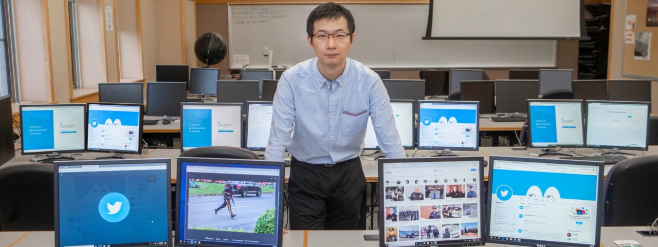 Minxuan Lan stands in a computer lab.