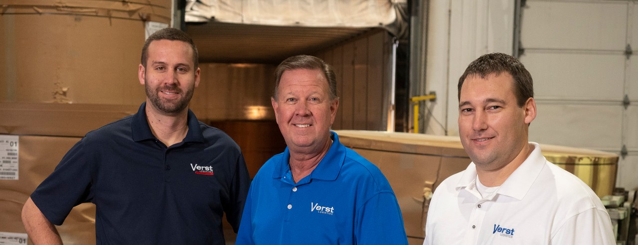 From left: Chris Verst, Paul Verst and Kyle Stadtmiller posing at Verst Logistics plant floor.