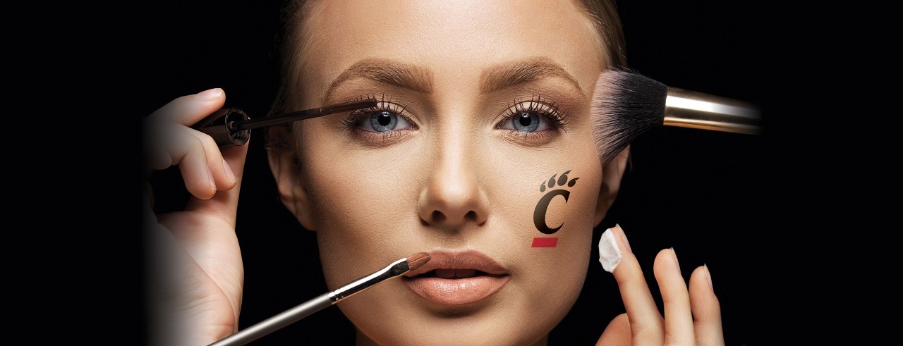 Woman's face with multiple makeup brushes 