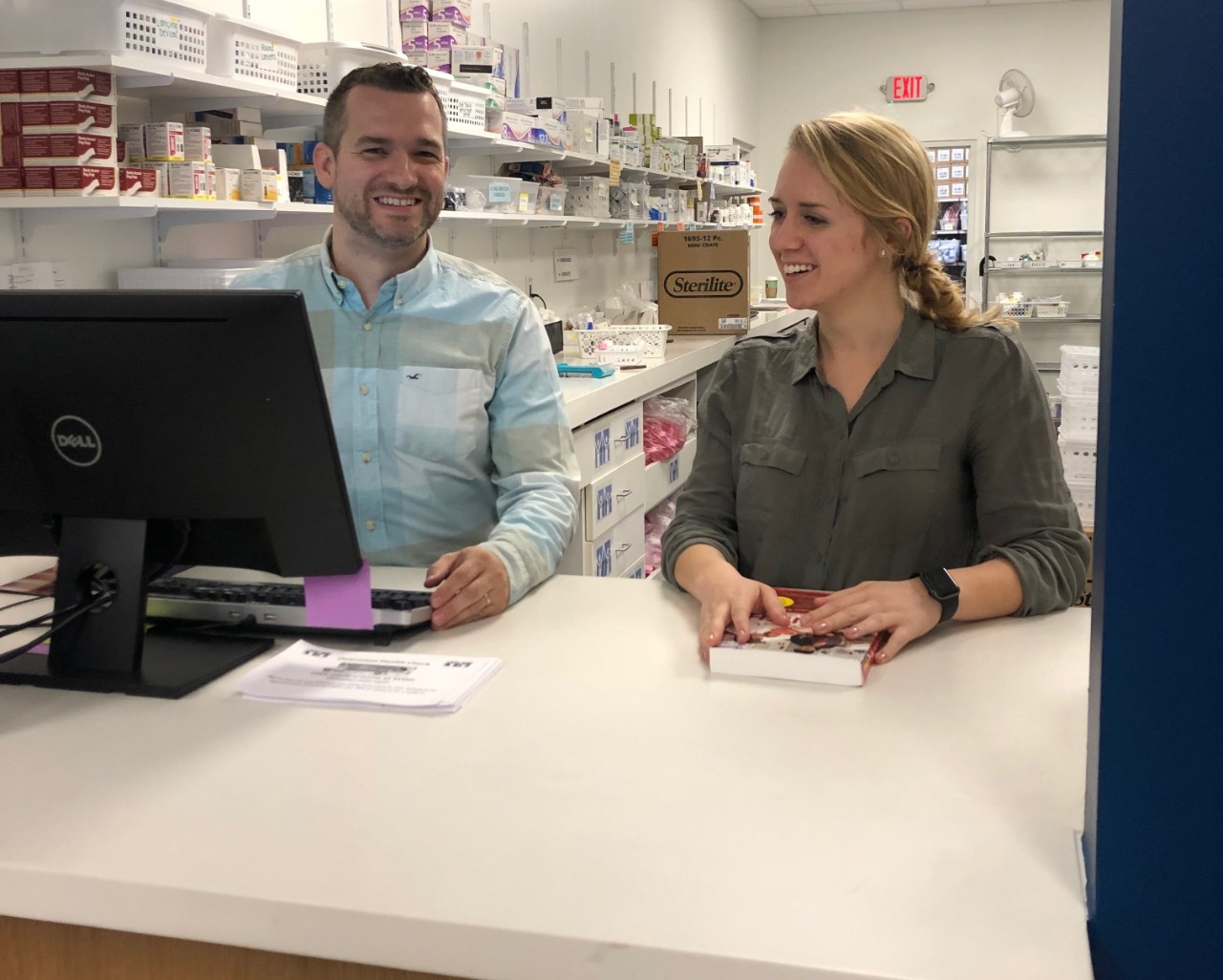 Katherine Pastor, a fourth-year nursing major, converses with St. Vincent De Paul’s Pharmacist.