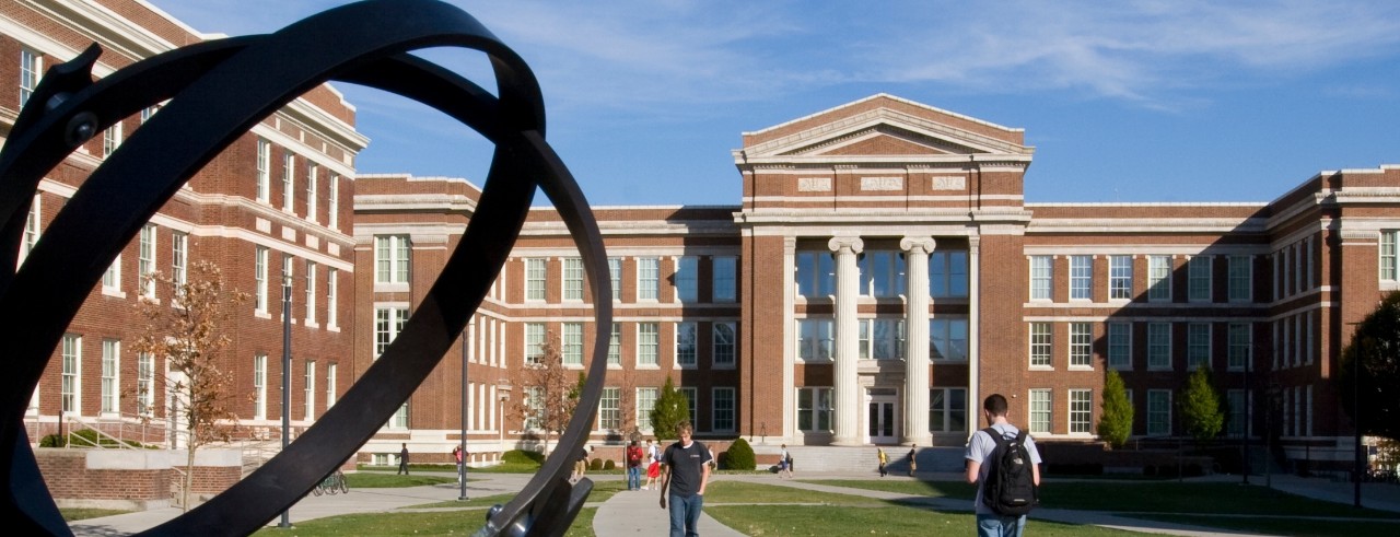 photo of Baldwin Hall quad, with students and the analemma sculpture in foreground on sunny day