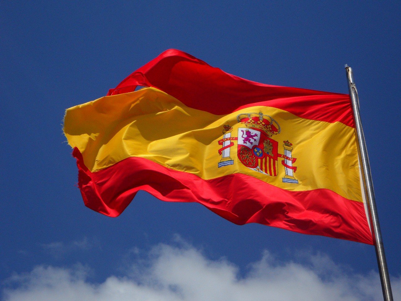 The Spanish flag flies in the wind.