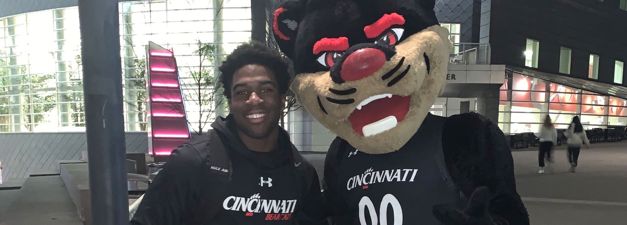 Josh Nworie with Bearcat mascot