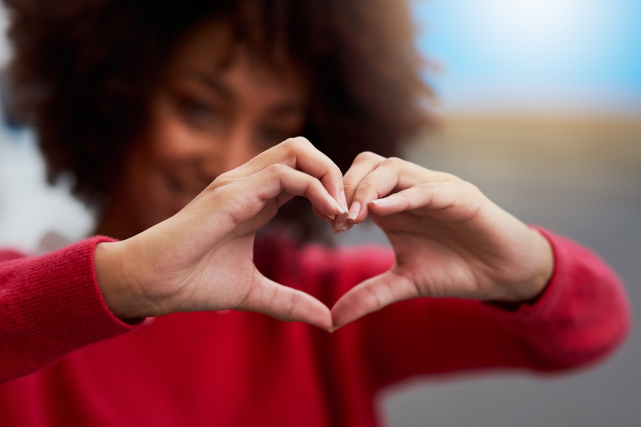 A woman making her hands into a heart