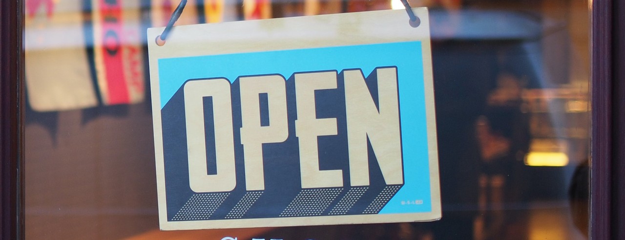 Open sign on business front glass door.