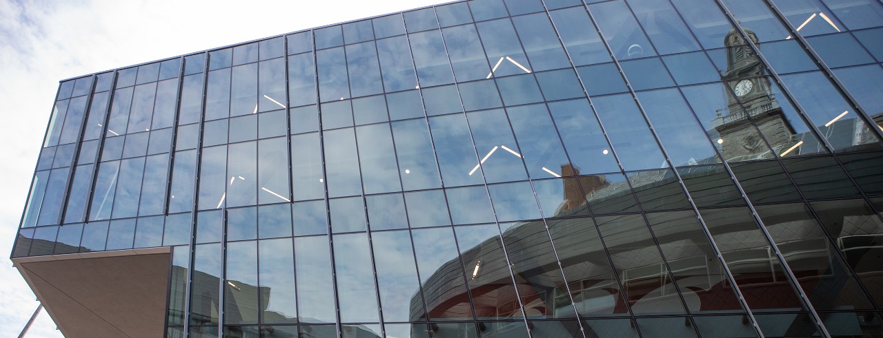 Tangeman University Center mirrored in the glass exterior of a nearby building