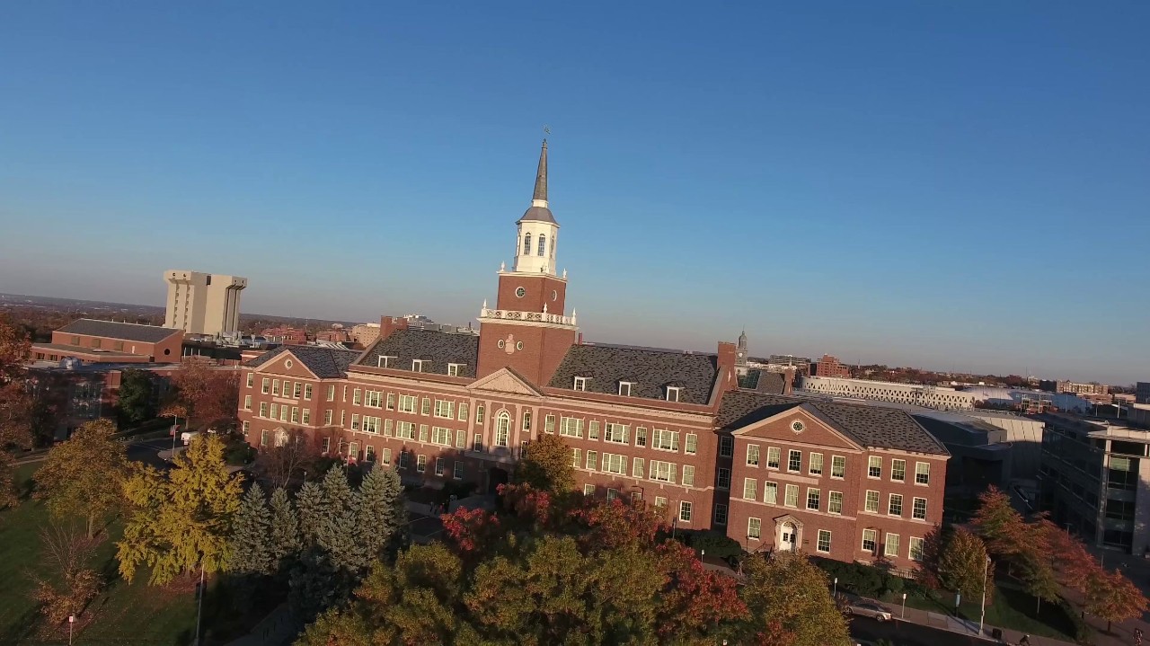 McMicken Hall dominates a cerulean sky in the evening. 