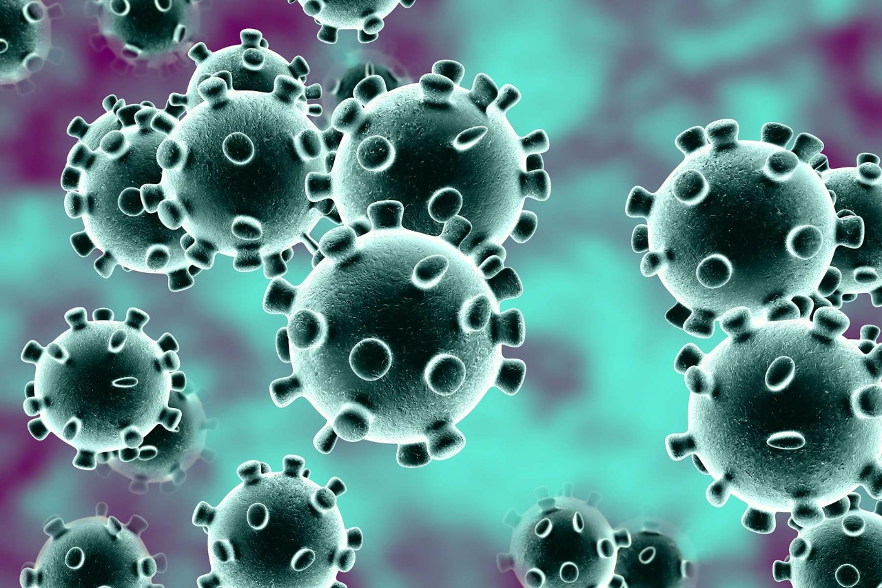A graphic of the coronavirus with a person wearing a facemask.