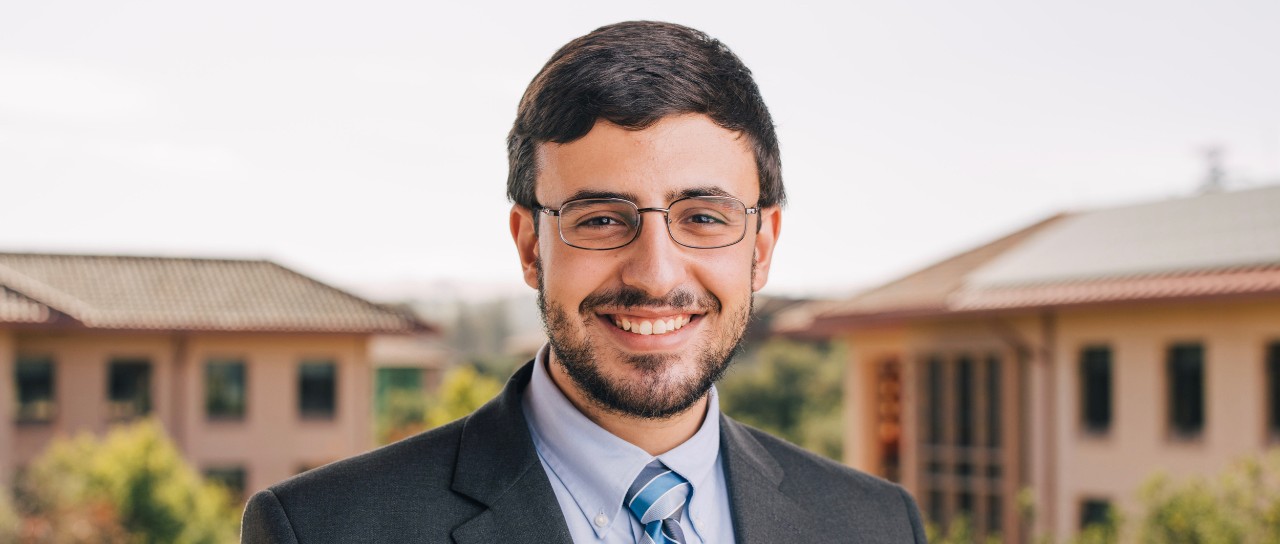 UC's Mohamed Elzarka in front of Stanford University campus buildings.