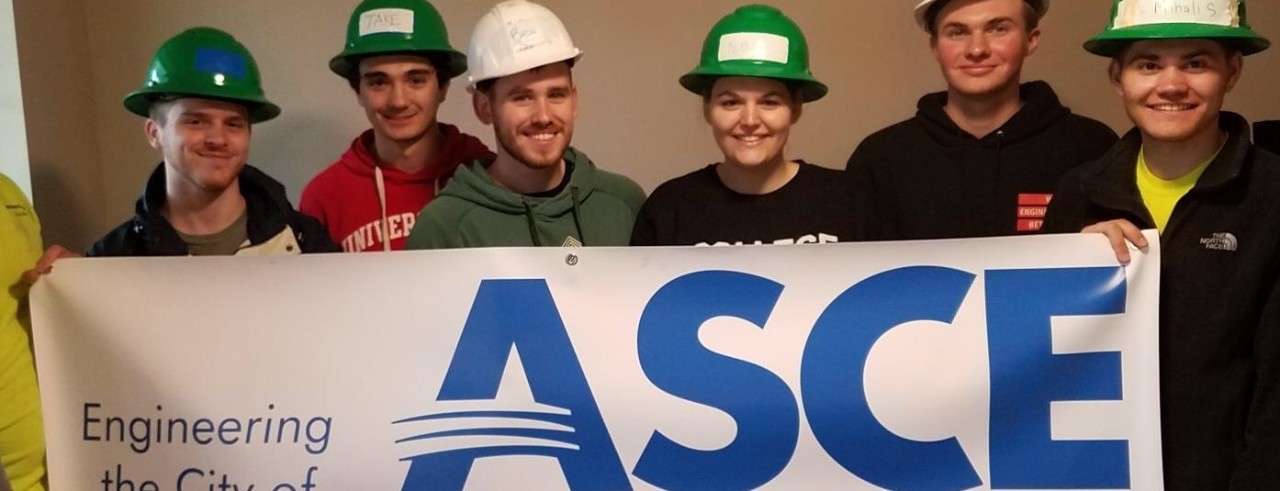 ASCE students hold a sign that says ASCE