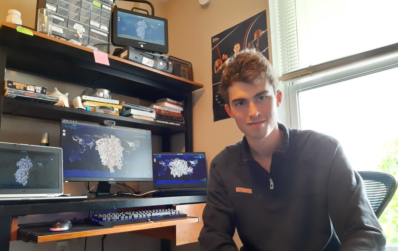 UC student Daniel Corcoran sits at his computer in his home office.