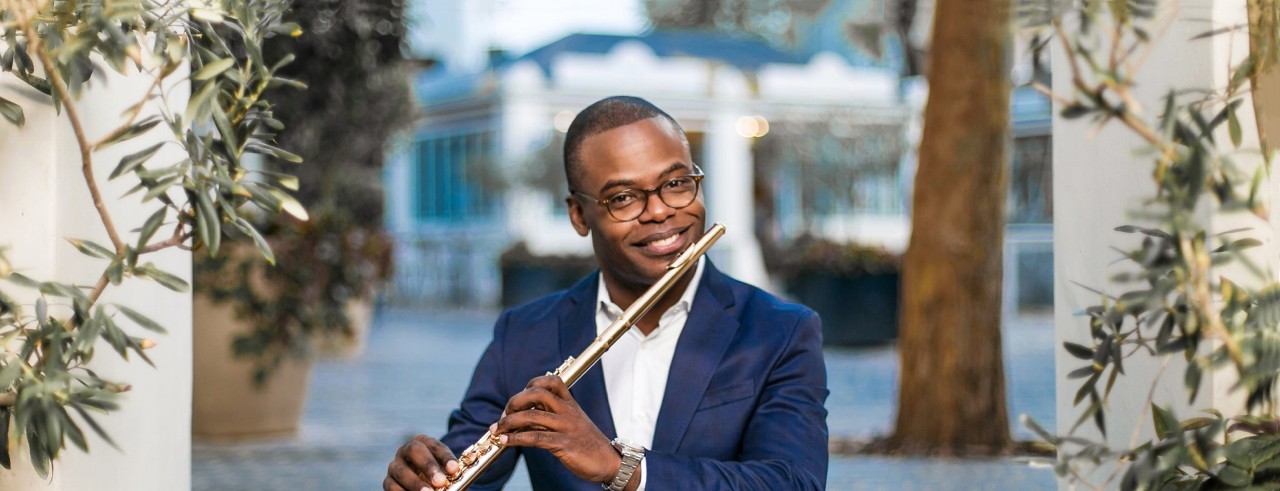 Flutist Demarre McGill poses with his instrument