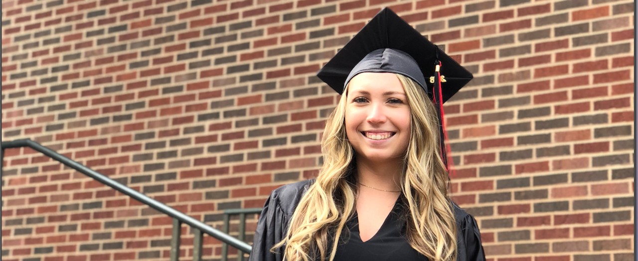 Sam Green wears her 2018 cap ad gown from UC.