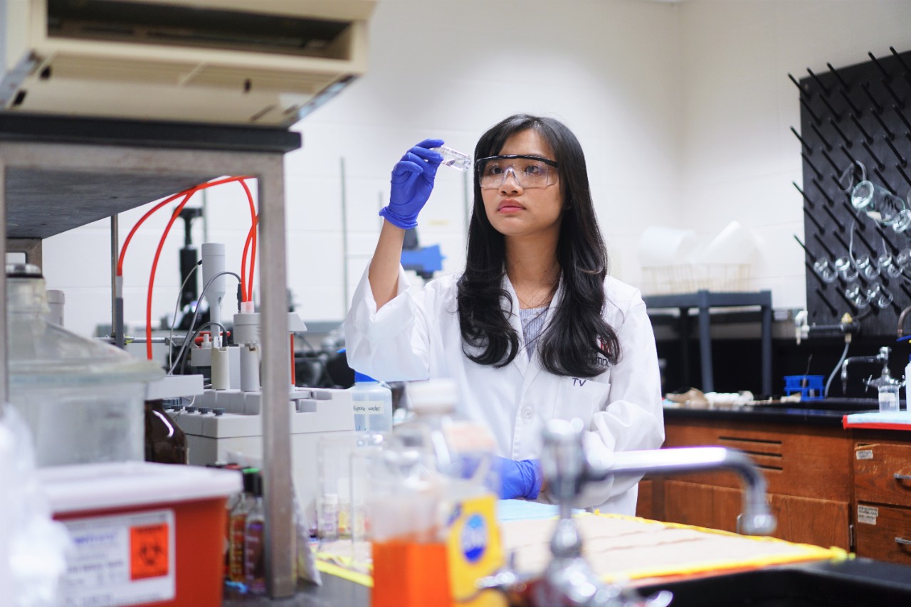 Cosmetic science researcher Vu Trang in her lab looking at a test tube