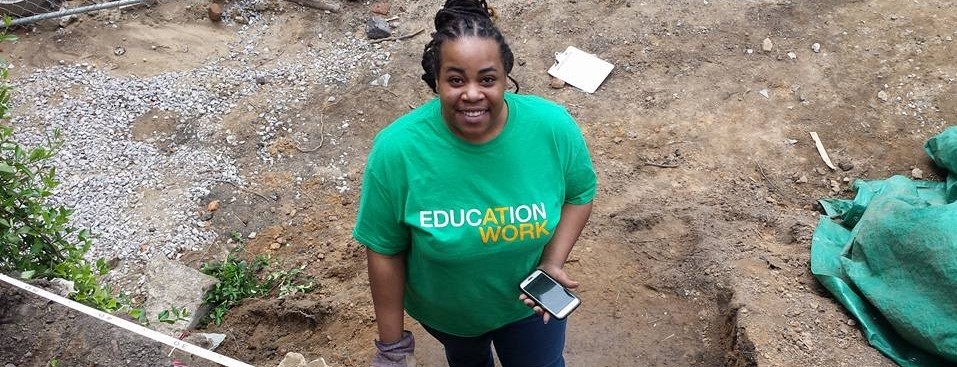 JeMiah Cannon smiles at the camera wearing an Education at Work T-shirt.